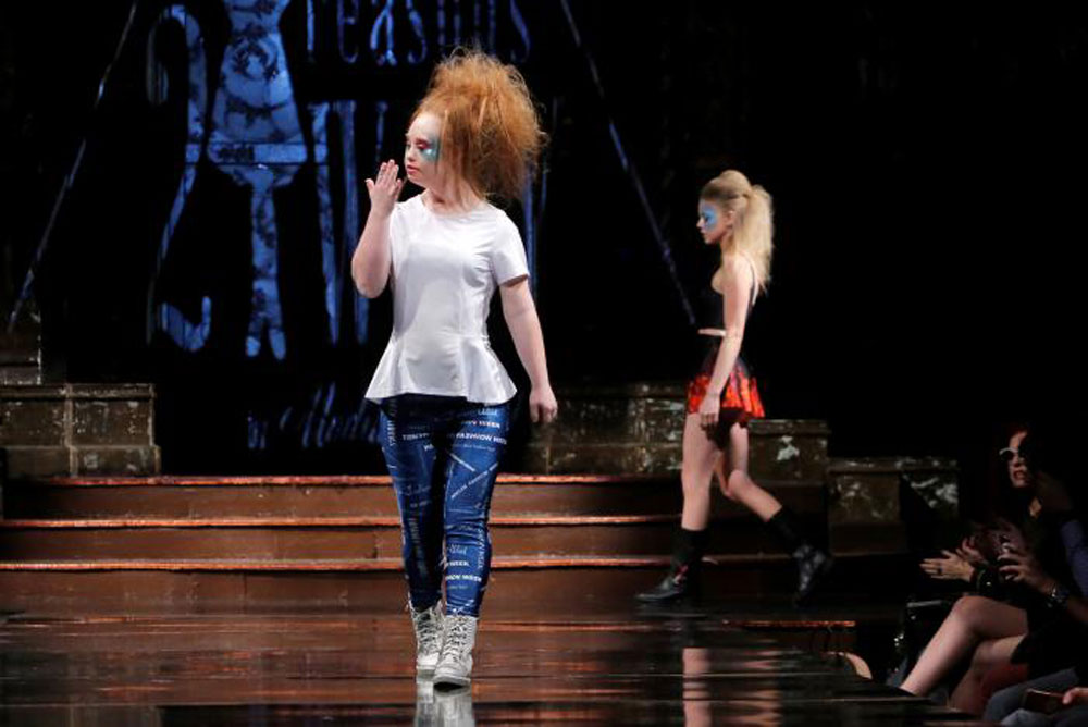 Madeline Stuart blows a kiss as she walks in her own show on Sunday (photo c/o AFP) 